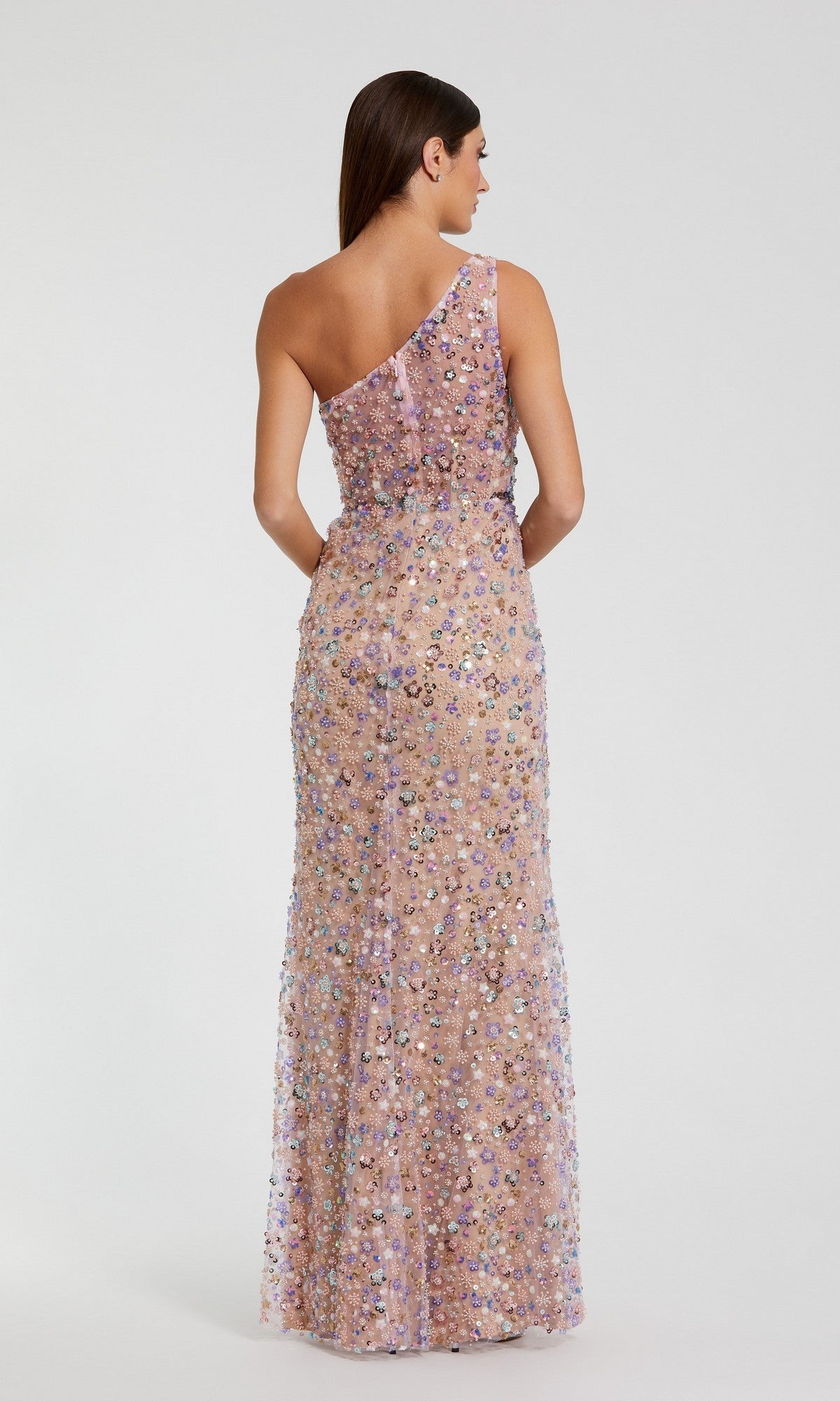 A woman is shown from the back wearing the Mac Duggal 68889 long prom dress, featuring a one-shoulder neckline and multicolored sequin embellishments, set against a plain light background.
